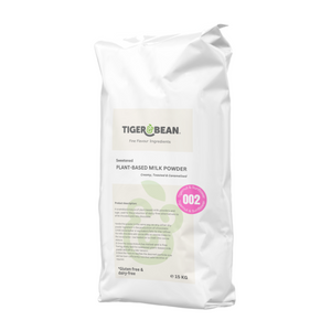A white sack of sweetened plant-based milk powder weighing 15 kg. Packaging states it is gluten-free and dairy-free and is used in the production of dairy-free alternatives to milk chocolate and white chocolate. A pink sticker states that it is recipe number 002 made with tigernut and sunflower. 